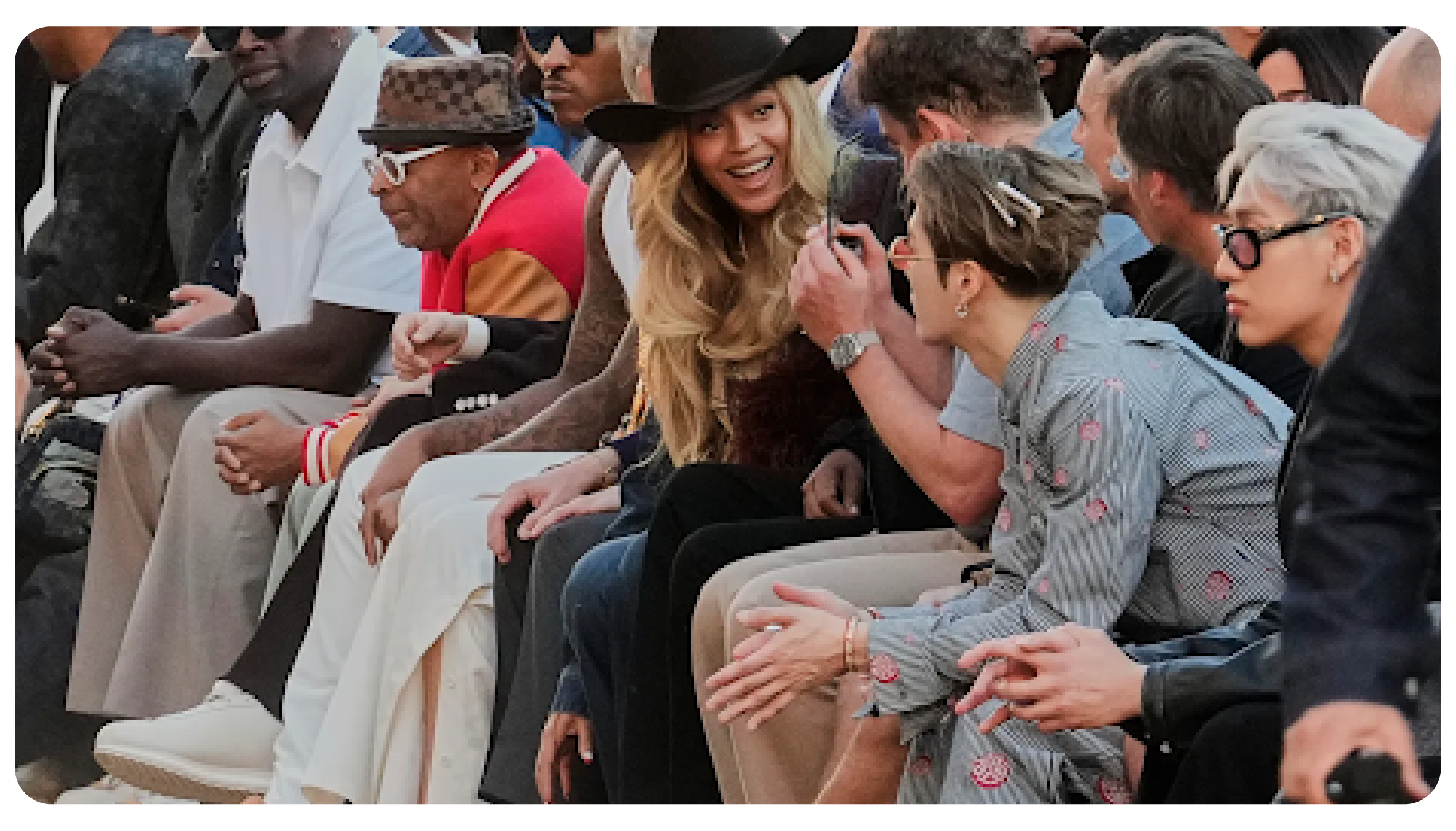 A smiling Beyoncé sits front row next to K-pop star Jackson Wang and other global celebrities at a high-profile Louis Vuitton fashion show.