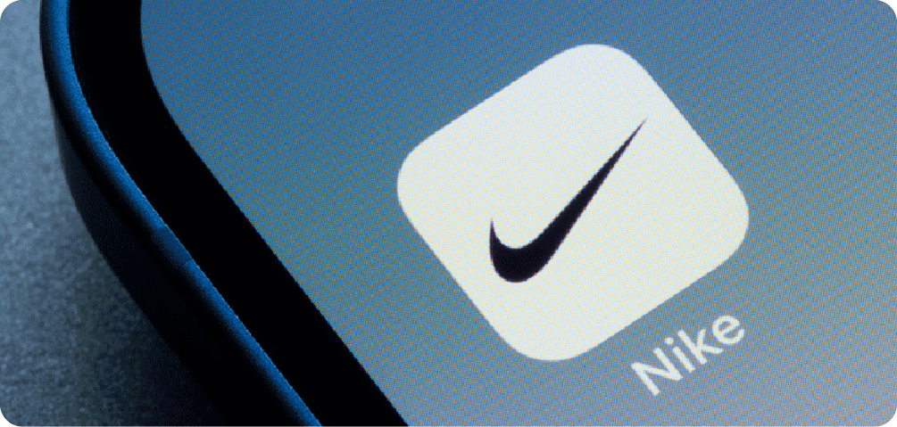 A close-up of the Nike app icon on a smartphone screen, representing Nike's digital branding strategy of connecting with its audience through mobile apps and community.