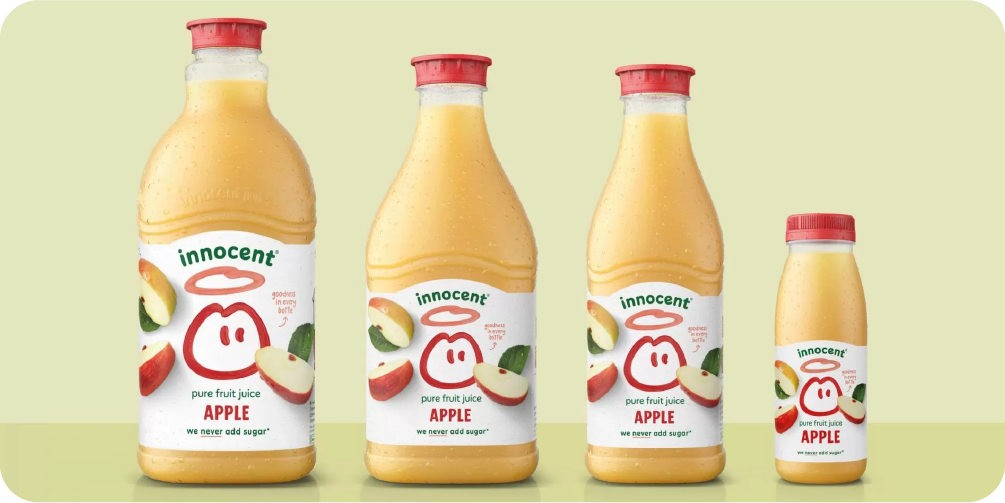 Bottles of Innocent apple juice featuring a simple, charming illustrative design of an apple with a halo, creating a friendly brand identity.